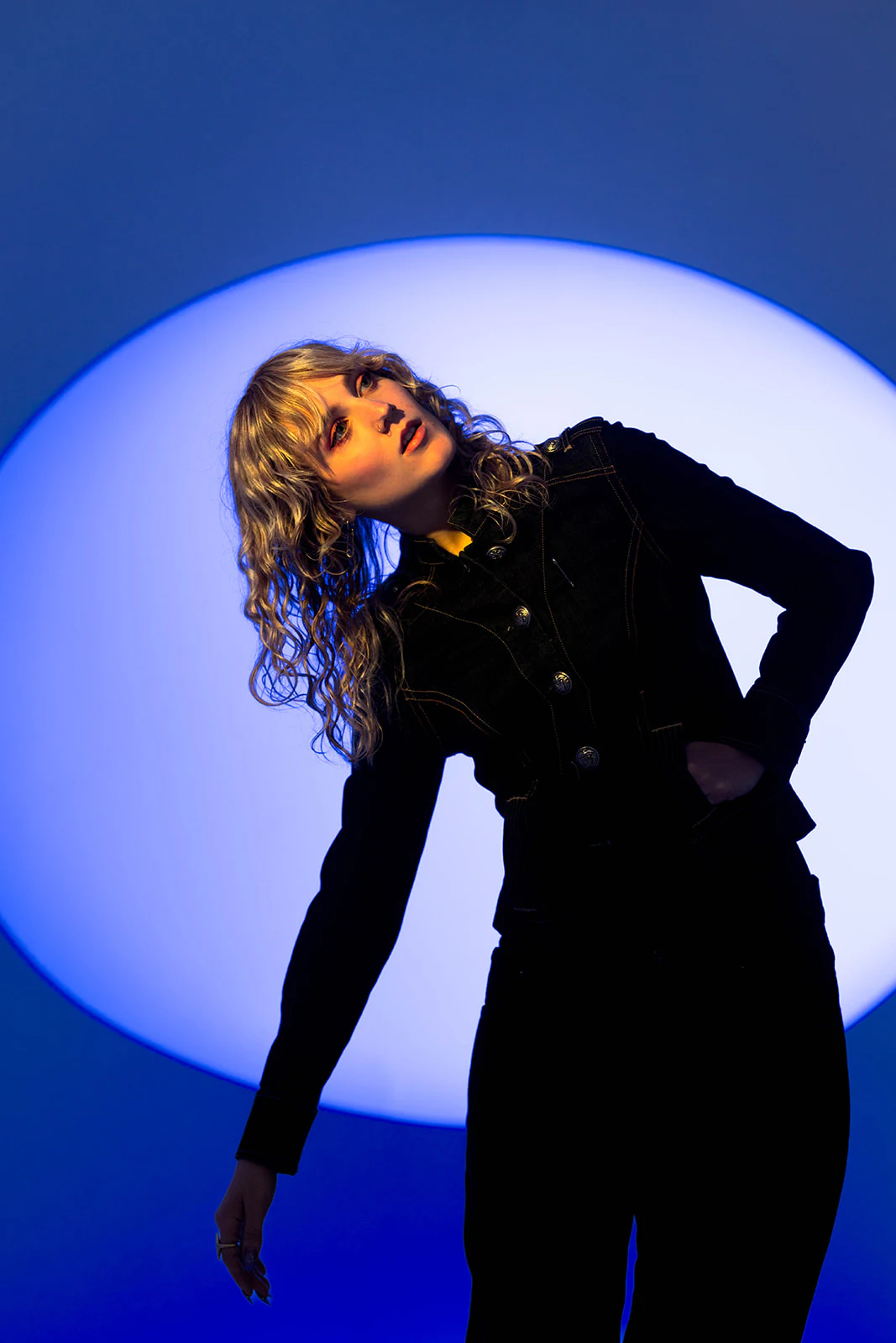 Olivia Carter performing under electric-blue light