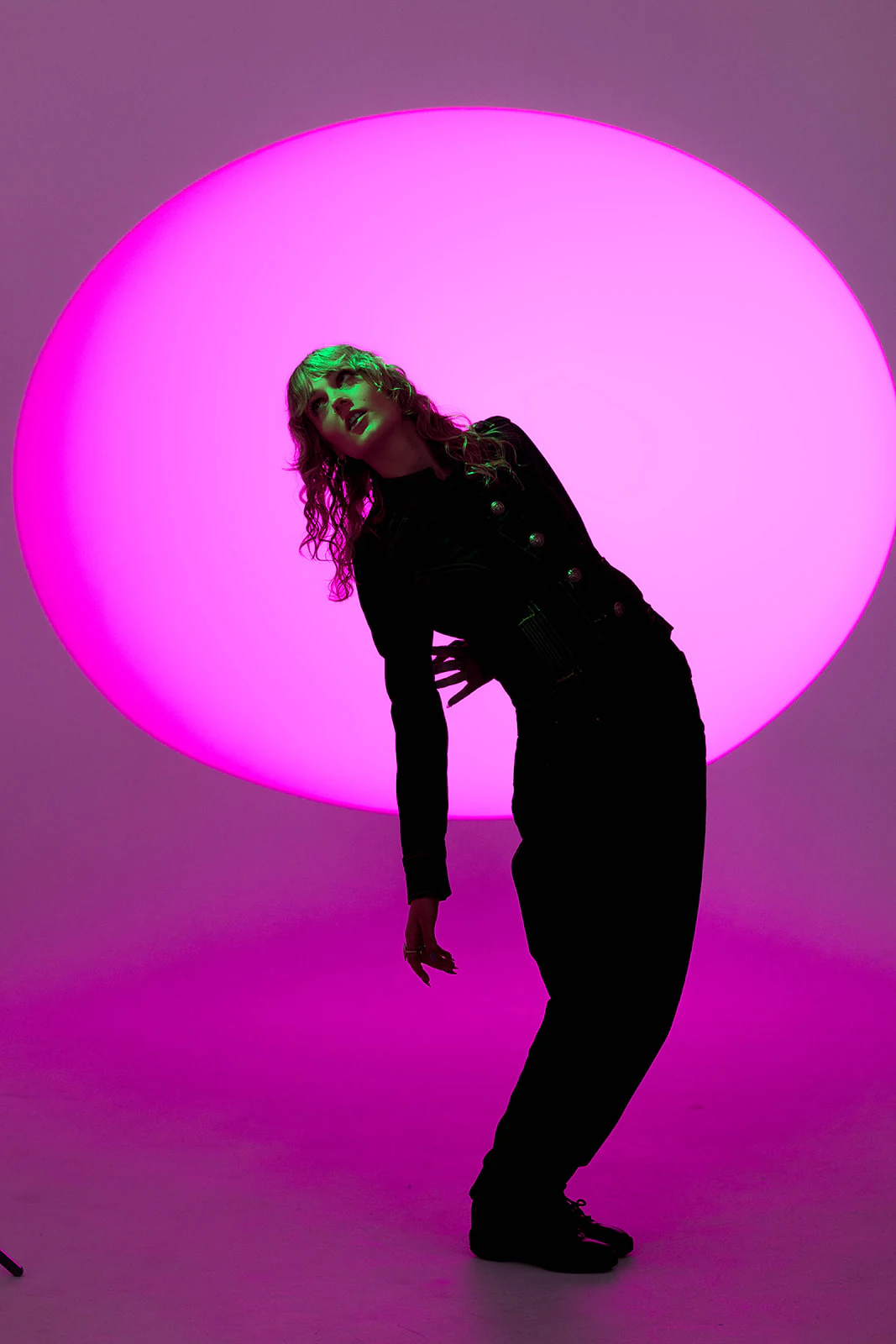 Olivia Carter performing under magenta light